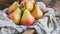 Fresh pears in a rustic basket with a linen cloth