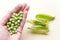 Fresh peas  on yelow background.Top view, selected focus