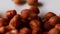 Fresh peeled hazelnuts drop from above