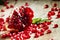 Fresh peeled pomegranates with ruby red beans on old wooden table, selective focus