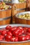 Fresh peppers and olives in barrels. Healthy food containing vitamins. Mediterranean snack