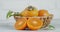 Fresh persimmon in basket with leaves rotates slowly.