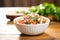 fresh pico de gallo in a white bowl on a wooden table