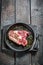 Fresh piece of red meat with rosemary and pepper ready to grill