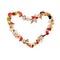 Fresh pieces of fruit flying in heart shape on white