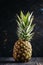 Fresh pineapple, dark wood background, selective focus