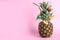 Fresh pineapple decorated with fruits and straw as summer cocktail on color background