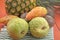 Fresh pineapple and exotic fruits on red background