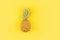Fresh pineapple on yellow background. Top view, mockup, template, overhead. Summer concept. Creative flat lay with copy space