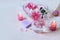 Fresh pink roses, water, petals, candles on a light background