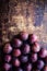 Fresh plums on a dark wood background. Top view image. Ripe Plu