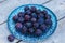 Fresh plums on an iridescent plate