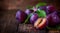 Fresh plums with leaves on a rustic wooden table