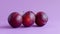 Fresh plums on purple background