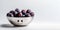 Fresh plums in a white bowl on a light background. A plate with a smiling face