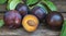 Fresh plums on wooden background