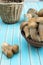 Fresh porcini mushrooms in earthenware basin on wooden turquoise table