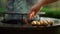 Fresh potatoes cooking on bbq grill outside. Man preparing potato outside