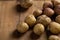 Fresh potatoes roots close up on wooden background