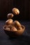 Fresh potatoes soaring above the wooden bowl on wooden textured background. Organic food, carbs, tubers.