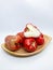 Fresh premiun quality rose apple or Syzygium samarangense with wooden bowl isolated on white background. Also known as wax apple,