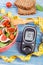 Fresh prepared fruit and vegetable salad and glucometer with tape measure, concept of healthy nutrition