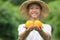 Fresh product of orange fruits on hand with smiling of young farmer