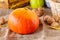 Fresh Pumpkin. Autumn fruits and vegetables. Autumn colors. Vibrant colors. Pumpkin, nuts and pear. Stocks for winter. Autumn is c