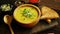 Fresh pumpkin soup in bowl on chopping board