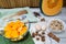 Fresh pumpkin squash on kitchen table with baking ingredients