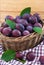 Fresh purple plums in a basket