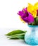Fresh purple tulip, yellow flowers close up on white background Bouquet snowdrops on wooden background. Spring