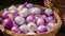 Fresh purple and white onions in a wicker basket