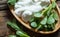 Fresh purslane Portulaca oleracea, edible weeds with yoghurt on wooden table