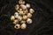 Fresh quail eggs on a black velvet background, quail eggs for a delicious Easter holiday