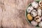 Fresh quail eggs on a wooden board. Vegetarian diet. Copy space.