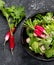 Fresh radish salad on drak gray background. Healthy food concept