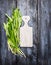 Fresh ramson on white cutting board and blue wooden background, top view, copy space