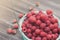 Fresh raspberries basket on brown rustic wood background