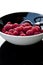 Fresh raspberries in black bowl