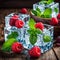 Fresh raspberries and mint leaves in ice cubes