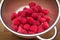 Fresh raspberries in stainless steel colander