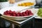 Fresh raspberry plate with spoon on black kitchen table, close-up