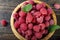 Fresh raspberry in a wooden plate