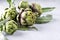 Fresh raw artichokes on grey background. Ripe organic artichoke flower