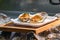 Fresh Raw big couple Oysters on the foam dish and wooden plate topping by fried garlic and leaf the ready to serve