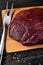Fresh raw buffalo meat on cutting board