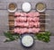 Fresh raw chicken pieces on skewers Seasoned Salt and garlic sauce greens on a cutting board