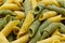 Fresh raw colored pasta. Italian Maccheroni al pettine on wooden table. Close-up background