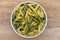 Fresh raw colored pasta. Italian Maccheroni al pettine on wooden table. View from above